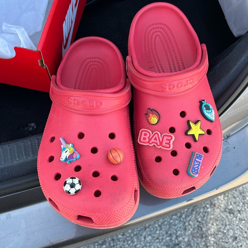 Worn and used Red crocs with gibets on them. As is! Wore them all the time!